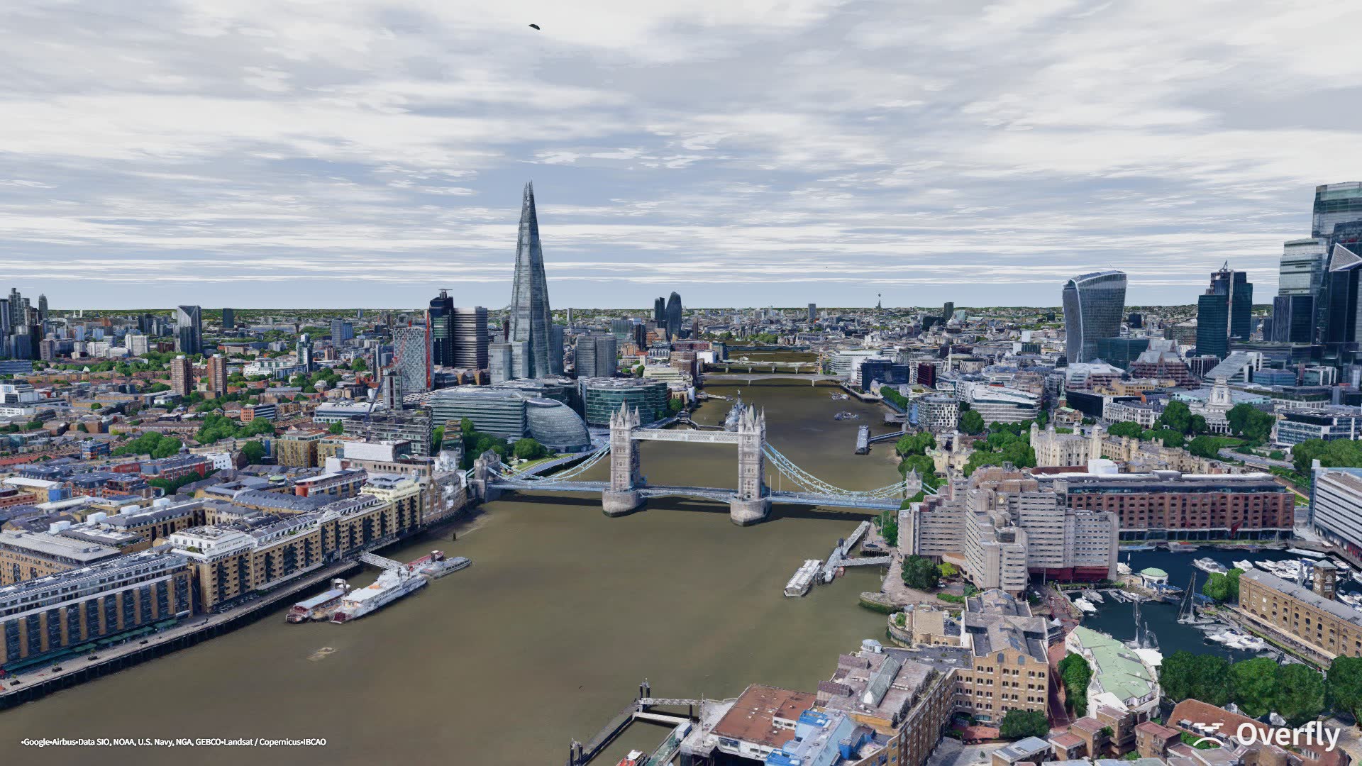 Overfly screenshot: Tower Bridge on a fair day with scattered cloud