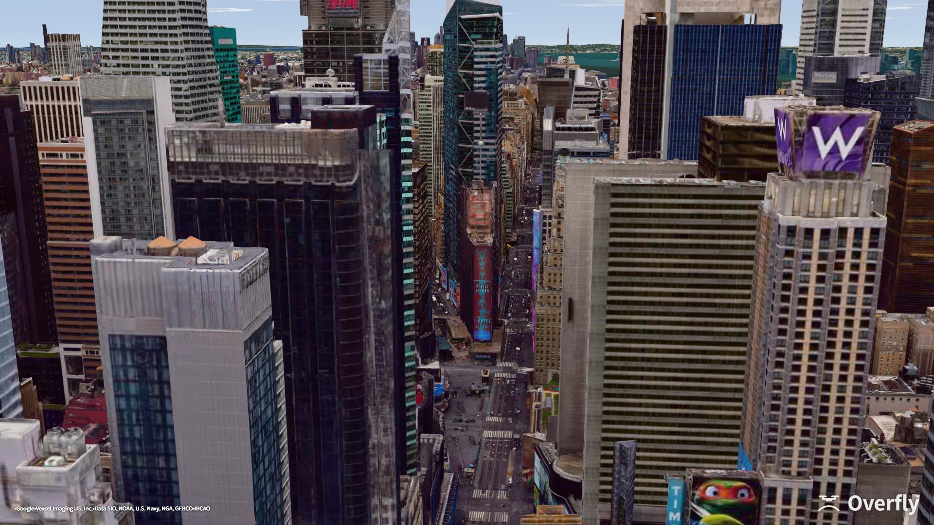 Overfly screenshot: the billboard canyon of Times Square seen from above Seventh Avenue, New York